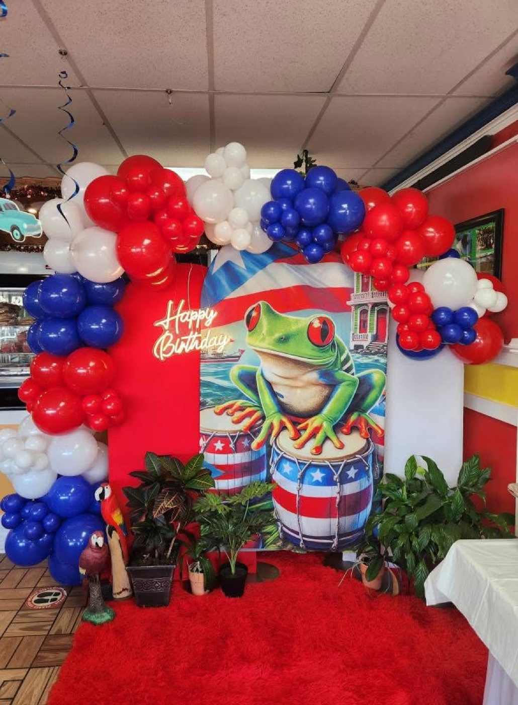 Colorful birthday balloon arch with a frog party theme