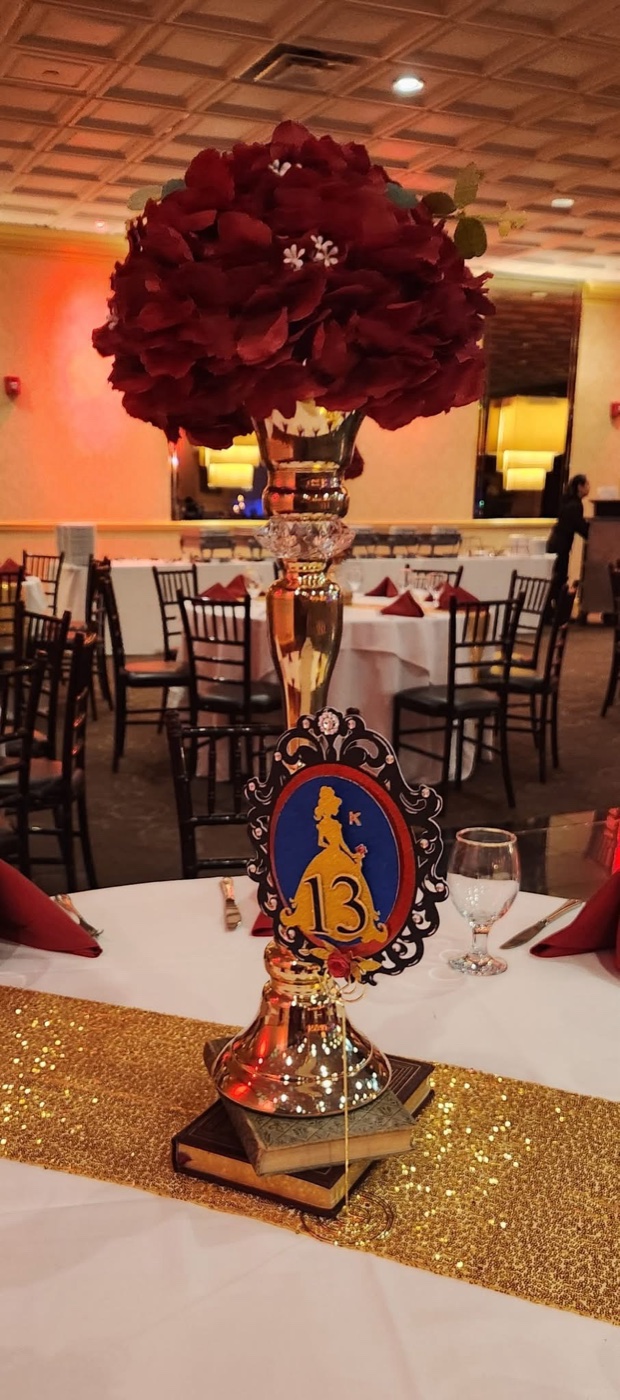 Formal floral centerpiece with red roses and table number